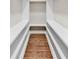 Spacious walk-in closet with hardwood floors and built-in shelving, offering ample storage space at 1121 S Edgemont Ave, Gastonia, NC 28054