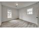 A bright and airy bedroom with two large windows and clean plank flooring at 113 Galilean Rd, York, SC 29745