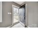 Inviting entryway featuring gray walls, plank flooring, and a glimpse of the front yard through the glass storm door at 113 Galilean Rd, York, SC 29745