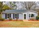 Charming single-story home with light blue siding and black shutters, complemented by a well-manicured lawn at 113 Galilean Rd, York, SC 29745