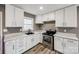 Updated kitchen features sleek stainless steel appliances and white cabinets at 113 Galilean Rd, York, SC 29745