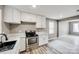 Bright kitchen featuring stainless steel appliances, white cabinets and wood look flooring at 113 Galilean Rd, York, SC 29745