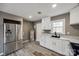 Bright kitchen featuring stainless steel refrigerator, white cabinets and wood look flooring at 113 Galilean Rd, York, SC 29745