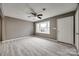Spacious, bright living area with plank floors, ceiling fan, and a large window offering natural light at 113 Galilean Rd, York, SC 29745