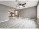 Bright and airy living room featuring plank floors that lead to a modern kitchen with sleek, white cabinets at 113 Galilean Rd, York, SC 29745