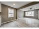 Living room showcasing plank floors, natural light, and an open layout, leading to kitchen with white cabinets at 113 Galilean Rd, York, SC 29745