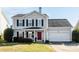 Charming two-story home with gray siding, black shutters, and a welcoming red front door at 11427 Lamoille Ln, Charlotte, NC 28278