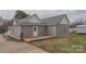 Exterior view of a home showcasing a wooden back deck, gray siding and neutral trim at 116 11Th St, Spencer, NC 28159