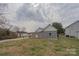View of the home's backyard with a wooden deck and spacious lawn at 116 11Th St, Spencer, NC 28159