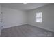 This bedroom features neutral paint, carpet, and a window providing natural light at 116 11Th St, Spencer, NC 28159