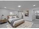 A bright bedroom featuring a light wood bed frame, artwork and a modern rug at 116 11Th St, Spencer, NC 28159