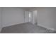 This bedroom features neutral paint, carpet, and a closet at 116 11Th St, Spencer, NC 28159