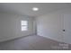 This bedroom features neutral paint, carpet, and a window providing natural light at 116 11Th St, Spencer, NC 28159