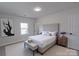 An airy bedroom with a decorative headboard, bench, and bedside tables with decor at 116 11Th St, Spencer, NC 28159