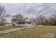 A charming home featuring a covered porch and a long driveway at 116 11Th St, Spencer, NC 28159