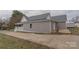 Side view of the house showcasing the patio and landscaping at 116 11Th St, Spencer, NC 28159