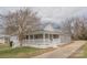 Inviting home featuring a covered porch that wraps around the side with a well-maintained front yard at 116 11Th St, Spencer, NC 28159