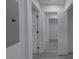 Hallway featuring multiple doors, neutral paint, and updated flooring at 116 11Th St, Spencer, NC 28159