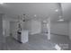 Hallway with modern flooring, neutral walls, and contemporary doors, leading to various rooms at 116 11Th St, Spencer, NC 28159