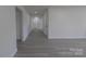 Hallway with modern flooring, neutral walls, and contemporary doors, leading to various rooms at 116 11Th St, Spencer, NC 28159