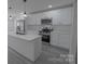 Bright kitchen featuring stainless steel appliances, white cabinets, and a functional island at 116 11Th St, Spencer, NC 28159