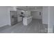 Modern kitchen with stainless steel appliances, white cabinets and adjacent living space at 116 11Th St, Spencer, NC 28159