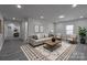 Neutral living room featuring a modern couch, wood coffee table and light walls and floors at 116 11Th St, Spencer, NC 28159