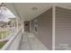 A spacious covered porch with white railings, perfect for outdoor living at 116 11Th St, Spencer, NC 28159