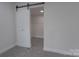 Bedroom featuring a walk-in closet with a sliding door and installed wire shelving at 116 11Th St, Spencer, NC 28159