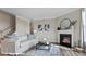 Inviting living room featuring a cozy fireplace, neutral decor, and natural light at 120 Asmodean Ln, Troutman, NC 28166