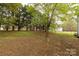 Large, private backyard with mature trees, a shed, and plenty of space for outdoor activities at 1200 Craig Ave, Lancaster, SC 29720