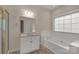 Bright bathroom features a bathtub and separate vanity with ample lighting and counter space at 1200 Craig Ave, Lancaster, SC 29720