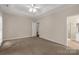 Large carpeted bedroom with a ceiling fan and en-suite bathroom at 1200 Craig Ave, Lancaster, SC 29720
