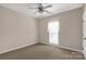 A simple bedroom with neutral tones, standard window, and a ceiling fan at 1200 Craig Ave, Lancaster, SC 29720
