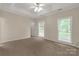 Large carpeted bedroom with a ceiling fan and plenty of natural light from the surrounding windows at 1200 Craig Ave, Lancaster, SC 29720