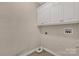 Functional laundry area with overhead cabinets and utility connections for modern appliances at 1200 Craig Ave, Lancaster, SC 29720