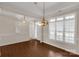 Inviting living room features a large window for natural light, chandelier, and hardwood floors at 1200 Craig Ave, Lancaster, SC 29720