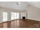 Cozy living room with fireplace, ceiling fan, and large windows offering ample natural light at 1200 Craig Ave, Lancaster, SC 29720