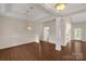 Bright living room boasts hardwood floors, neutral paint, and elegant chandelier lighting at 1200 Craig Ave, Lancaster, SC 29720