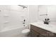 Bathroom features a single vanity with dark wood cabinets and a shower-tub combination with tile surround at 122 Asmodean Ln, Troutman, NC 28166