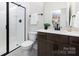 Bathroom featuring glass door shower, dark wood vanity, and brushed hardware at 122 Asmodean Ln, Troutman, NC 28166