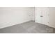 Neutral bedroom boasts soft carpet and white trim complemented by a closet with double doors at 122 Asmodean Ln, Troutman, NC 28166
