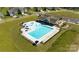 Aerial view of the community pool area, complete with lap lanes, splash pad, lounge chairs, and playground at 122 Asmodean Ln, Troutman, NC 28166