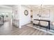 Bright dining area featuring modern decor, wainscotting, and hardwood floors, with an adjacent hall at 122 Asmodean Ln, Troutman, NC 28166