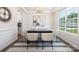 Dining room with wainscotting, hardwood floors, modern lighting, and adjacent to large window at 122 Asmodean Ln, Troutman, NC 28166
