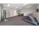A well-equipped gym features treadmills, free weights, exercise balls, and a wall-mounted television for a complete workout experience at 122 Asmodean Ln, Troutman, NC 28166