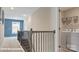 Upstairs hallway with laundry room area and staircase, offering functionality and style at 122 Asmodean Ln, Troutman, NC 28166