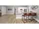A well-lit, neutral-toned kitchen features white cabinetry, stainless steel appliances, and a granite breakfast bar with seating at 122 Asmodean Ln, Troutman, NC 28166