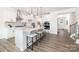 Modern kitchen with white cabinets, quartz countertops, stainless steel appliances, and a large island at 122 Asmodean Ln, Troutman, NC 28166