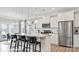 Bright kitchen features stainless steel appliances and a large island with bar stool seating at 122 Asmodean Ln, Troutman, NC 28166
